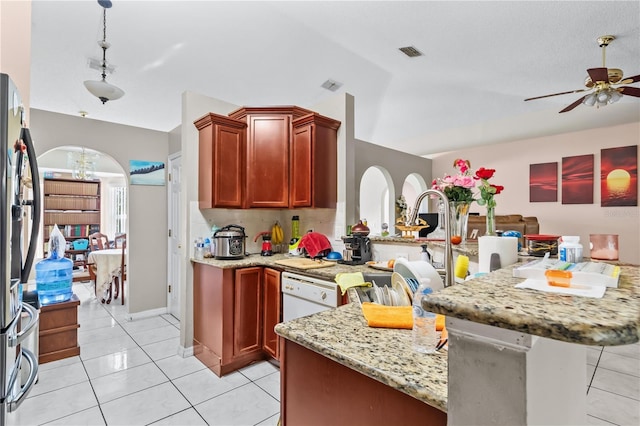 14 Sequoia Way, Kissimmee, FL 34758 - kitchen featuring freestanding refrigerator, light stone countertops, dark brown cabinets, ceiling fan, and light tile patterned flooring