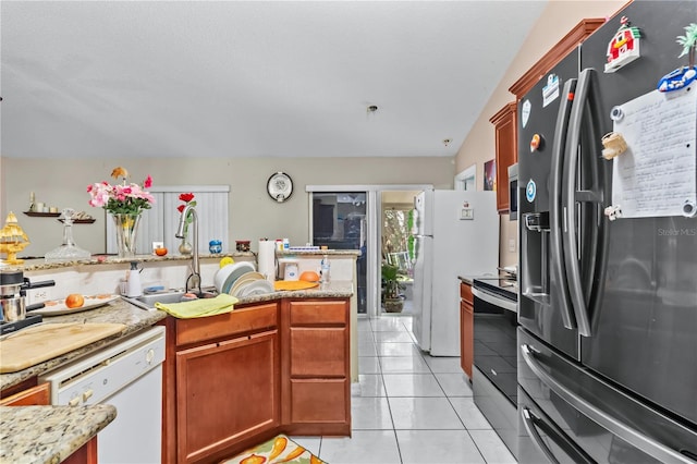14 Sequoia Way, Kissimmee, FL 34758 - kitchen with appliances with stainless steel finishes, light tile patterned floors, a sink, and light stone counters