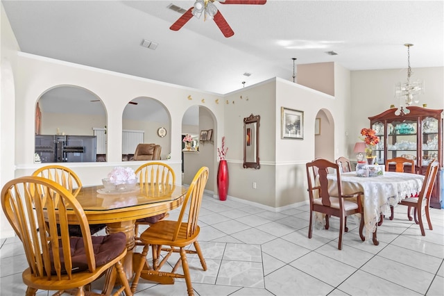 14 Sequoia Way, Kissimmee, FL 34758 - dining space featuring vaulted ceiling, a ceiling fan, light tile patterned floors, baseboards, and arched walkways