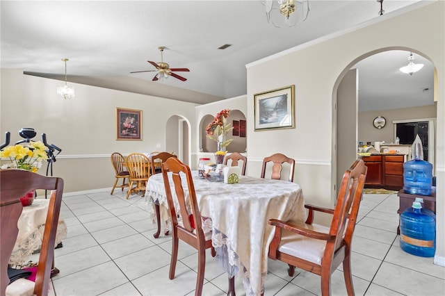 14 Sequoia Way, Kissimmee, FL 34758 - dining room featuring arched walkways, light tile patterned floors, ceiling fan, lofted ceiling, and baseboards