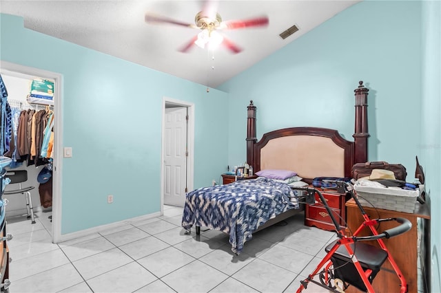 14 Sequoia Way, Kissimmee, FL 34758 - bedroom with a walk in closet, light tile patterned floors, a closet, vaulted ceiling, and a ceiling fan