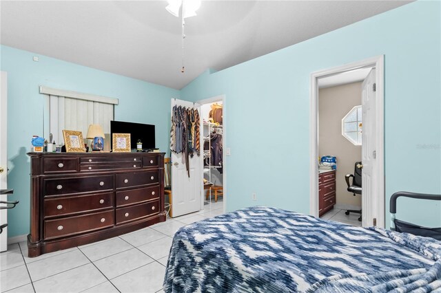 14 Sequoia Way, Kissimmee, FL 34758 - bedroom featuring light tile patterned flooring, a spacious closet, lofted ceiling, ensuite bath, and a closet