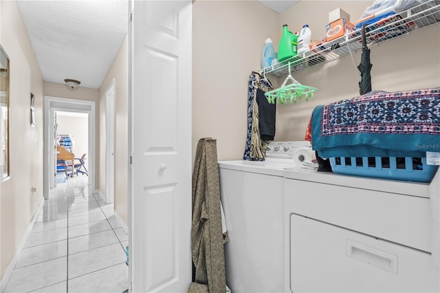 14 Sequoia Way, Kissimmee, FL 34758 - laundry room featuring independent washer and dryer, light tile patterned flooring, a textured ceiling, and baseboards