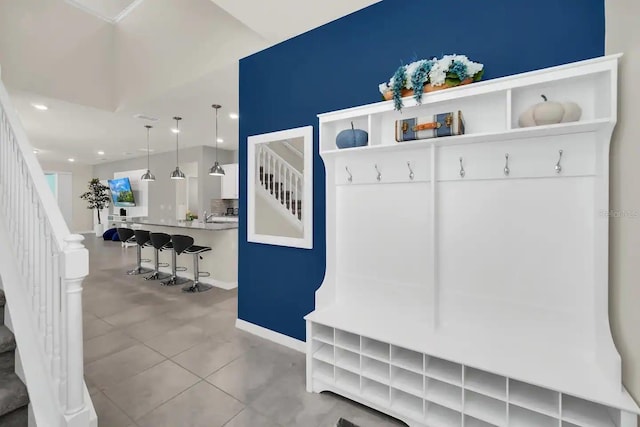 mudroom featuring baseboards, tile patterned floors, and recessed lighting