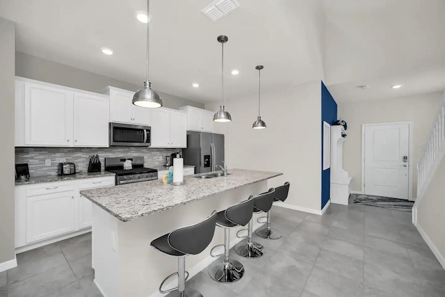 kitchen with stainless steel appliances, backsplash, white cabinets, baseboards, and recessed lighting