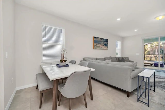 dining room with baseboards and recessed lighting