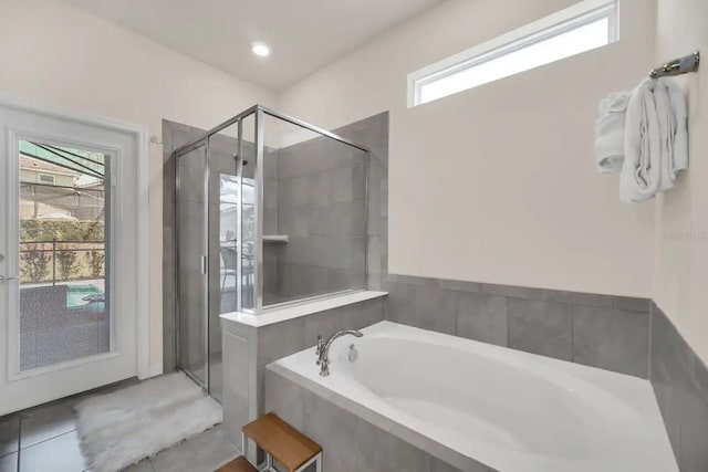 full bath with a stall shower and a garden tub