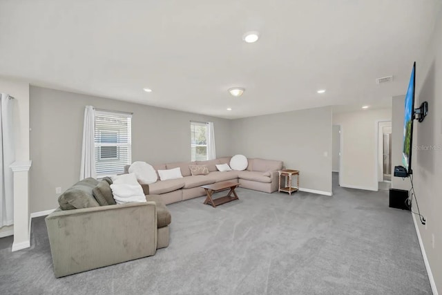 carpeted living area with baseboards and recessed lighting