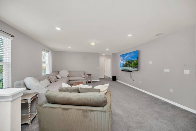 living room featuring carpet flooring, baseboards, and recessed lighting
