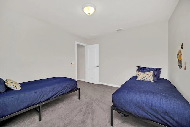 carpeted bedroom featuring baseboards