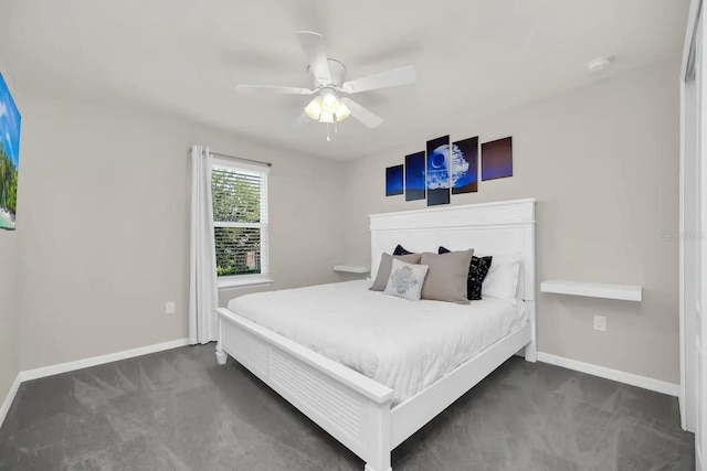 bedroom featuring dark colored carpet, baseboards, and a ceiling fan