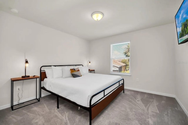 bedroom featuring carpet flooring and baseboards