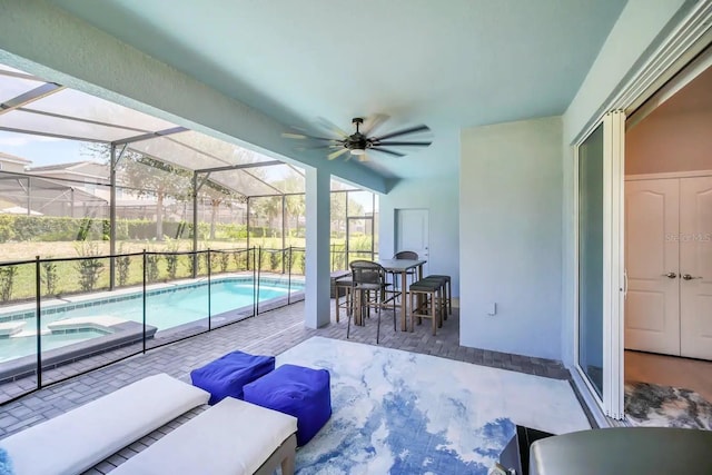 view of patio with an in-ground hot tub, an outdoor pool, ceiling fan, a lanai, and outdoor lounge area