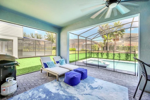 sunroom featuring a hot tub and ceiling fan