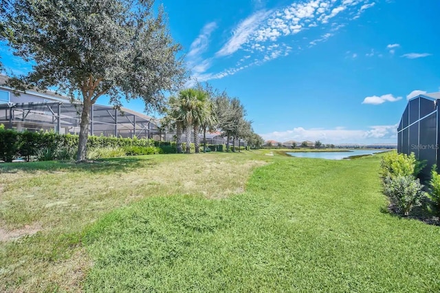 view of grassy yard with a water view