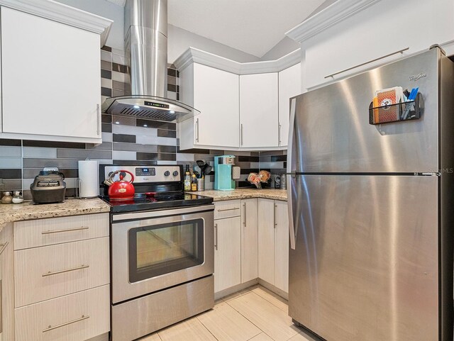 1064 Universal Rest Pl, Kissimmee, FL 34744 - kitchen featuring appliances with stainless steel finishes, wall chimney exhaust hood, tasteful backsplash, light stone counters, and white cabinetry