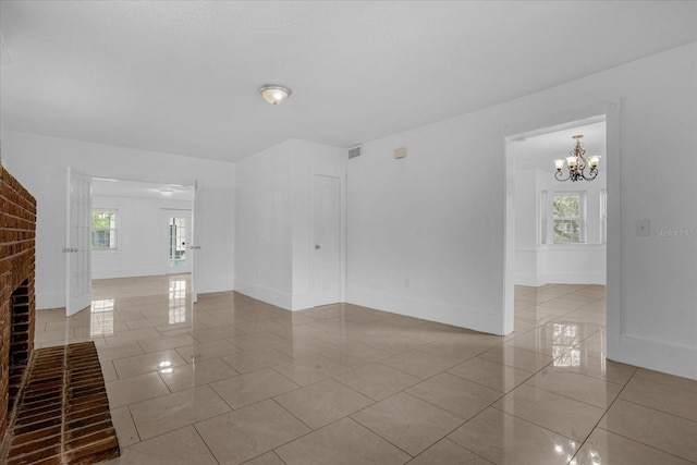 490 Shoreview Ave, Winter Park, FL 32789 - unfurnished room with light tile patterned flooring, plenty of natural light, and baseboards