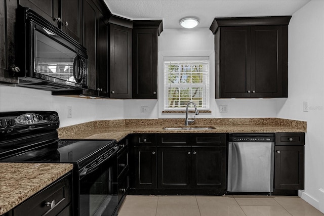 490 Shoreview Ave, Winter Park, FL 32789 - kitchen with black appliances, a sink, dark cabinets, light stone countertops, and light tile patterned floors