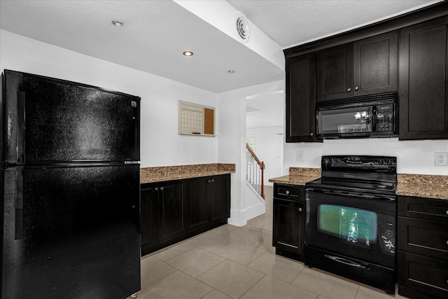 490 Shoreview Ave, Winter Park, FL 32789 - kitchen featuring black appliances, dark cabinets, and light stone countertops