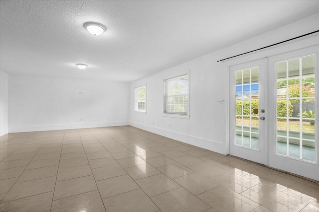 490 Shoreview Ave, Winter Park, FL 32789 - tiled empty room featuring french doors, baseboards, and a textured ceiling