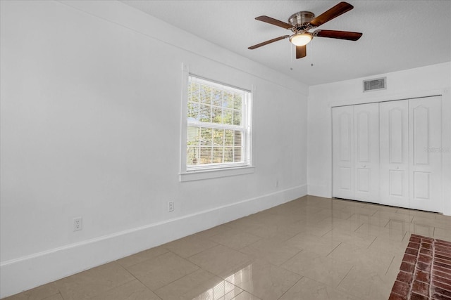 490 Shoreview Ave, Winter Park, FL 32789 - unfurnished bedroom with baseboards, tile patterned floors, a closet, and a ceiling fan