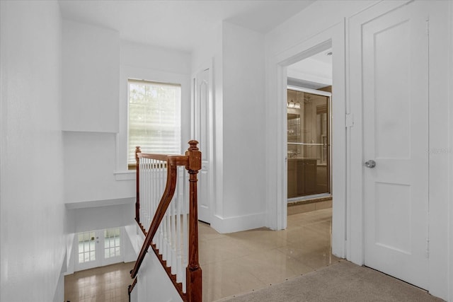 490 Shoreview Ave, Winter Park, FL 32789 - hallway with healthy amount of natural light, tile patterned flooring, baseboards, and an upstairs landing