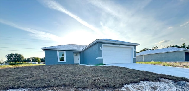 ranch-style house with driveway, stucco siding, and a garage