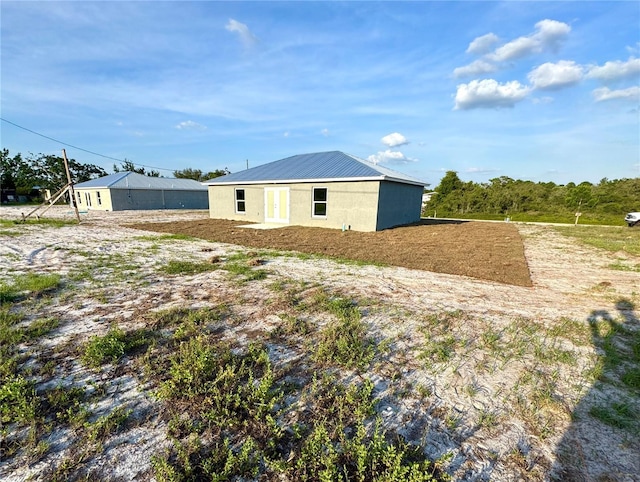rear view of property with metal roof
