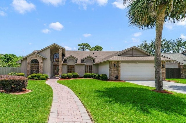 513 Sabal Trail Cir, Longwood, FL 32779 - view of front of house featuring a garage, driveway, and brick siding