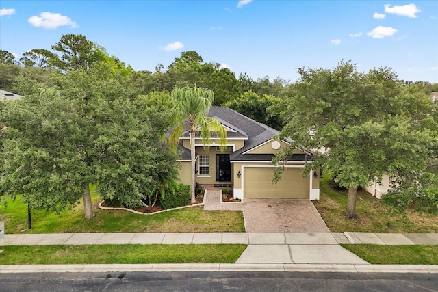 1601 Stargazer Ter, Sanford, FL 32771 - view of front of house featuring stucco siding, driveway, a garage, and a front yard