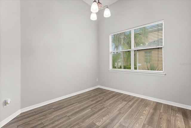 1601 Stargazer Ter, Sanford, FL 32771 - empty room with wood finished floors, baseboards, and a chandelier