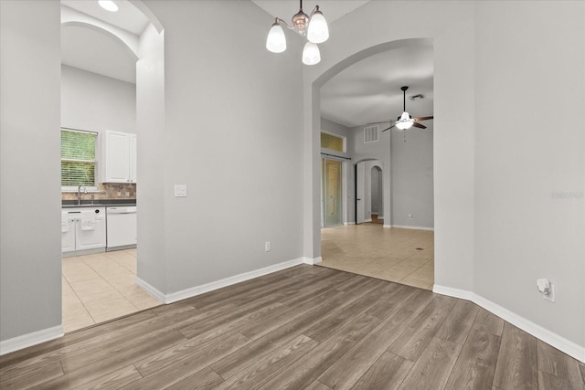 1601 Stargazer Ter, Sanford, FL 32771 - spare room featuring a ceiling fan, arched walkways, light wood-style flooring, and a towering ceiling