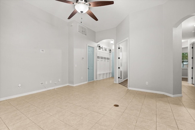 1601 Stargazer Ter, Sanford, FL 32771 - unfurnished room featuring arched walkways, a ceiling fan, light tile patterned floors, and baseboards
