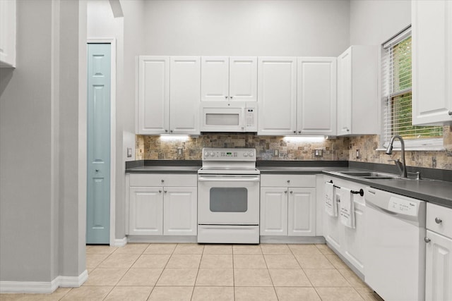 1601 Stargazer Ter, Sanford, FL 32771 - kitchen featuring white appliances, dark countertops, decorative backsplash, and white cabinets