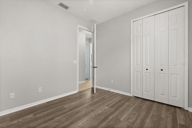 1601 Stargazer Ter, Sanford, FL 32771 - unfurnished bedroom featuring dark wood-type flooring, a closet, and baseboards