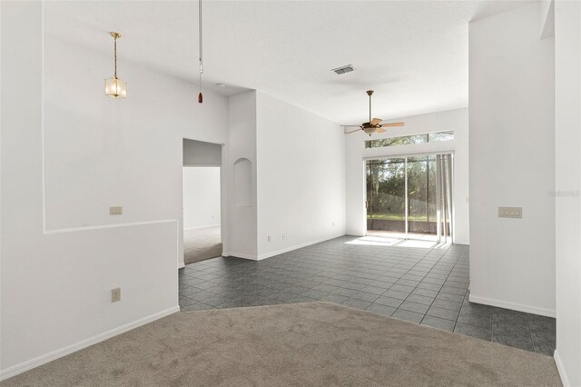 4520 Barrister Dr, Clermont, FL 34711 - spare room with ceiling fan, tile patterned flooring, carpet, and baseboards