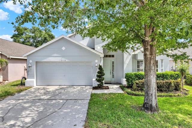 2776 Joseph Cir, Oviedo, FL 32765 - view of front of house featuring an attached garage, concrete driveway, stucco siding, and a front lawn