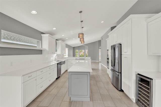 2776 Joseph Cir, Oviedo, FL 32765 - kitchen with appliances with stainless steel finishes, beverage cooler, a peninsula, light countertops, and recessed lighting