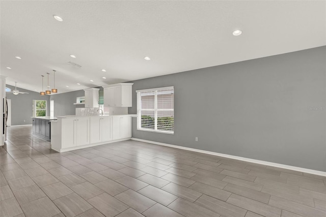 2776 Joseph Cir, Oviedo, FL 32765 - kitchen with open floor plan, recessed lighting, a peninsula, light countertops, and white cabinets