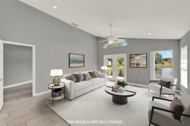 2776 Joseph Cir, Oviedo, FL 32765 - living room featuring lofted ceiling, baseboards, ceiling fan, wood finish floors, and french doors