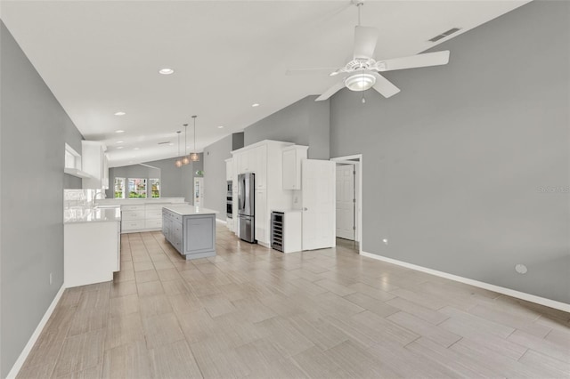 2776 Joseph Cir, Oviedo, FL 32765 - kitchen featuring stainless steel appliances, a ceiling fan, a kitchen island, beverage cooler, and open floor plan