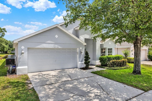 2776 Joseph Cir, Oviedo, FL 32765 - single story home with stucco siding, concrete driveway, an attached garage, and a front yard
