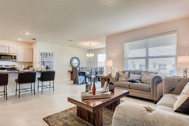 5169 Masser Rd, Saint Cloud, FL 34772 - living room with a chandelier, a textured ceiling, light tile patterned floors, and recessed lighting