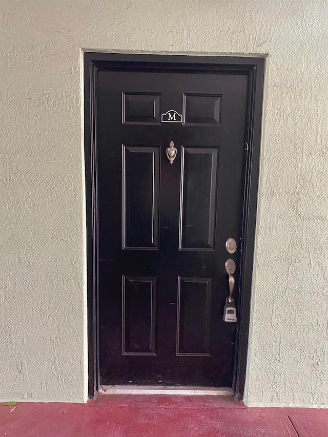 2007 Dixie Belle Dr Unit 2007M, Orlando, FL 32812 - doorway to property with stucco siding