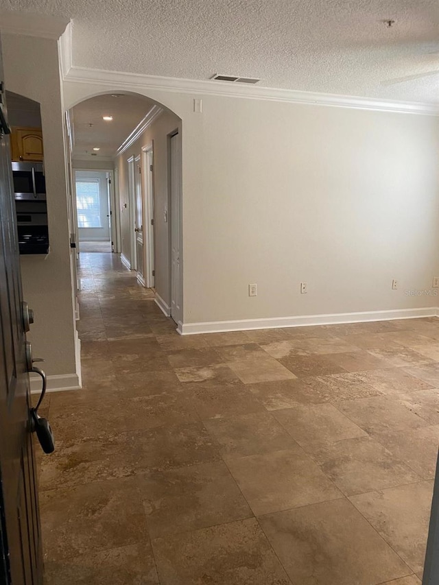 2007 Dixie Belle Dr Unit 2007M, Orlando, FL 32812 - hall featuring arched walkways, crown molding, a textured ceiling, and baseboards