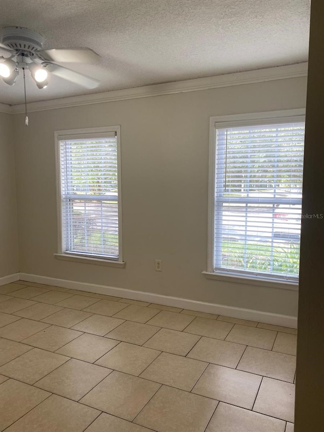 2007 Dixie Belle Dr Unit 2007M, Orlando, FL 32812 - empty room featuring crown molding, ceiling fan, baseboards, a textured ceiling, and light tile patterned floors