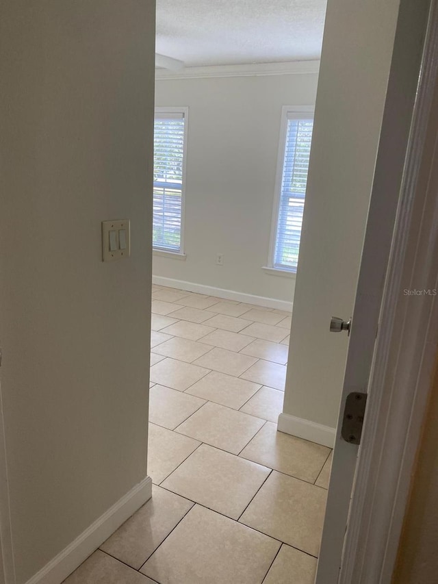 2007 Dixie Belle Dr Unit 2007M, Orlando, FL 32812 - empty room featuring baseboards, ornamental molding, and light tile patterned floors