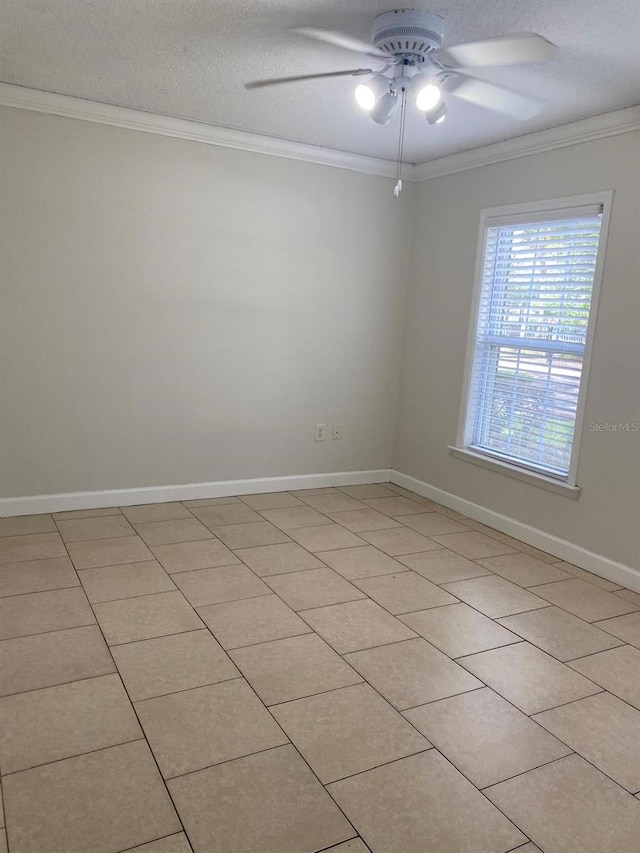 2007 Dixie Belle Dr Unit 2007M, Orlando, FL 32812 - spare room featuring ornamental molding, a ceiling fan, baseboards, light tile patterned floors, and a textured ceiling