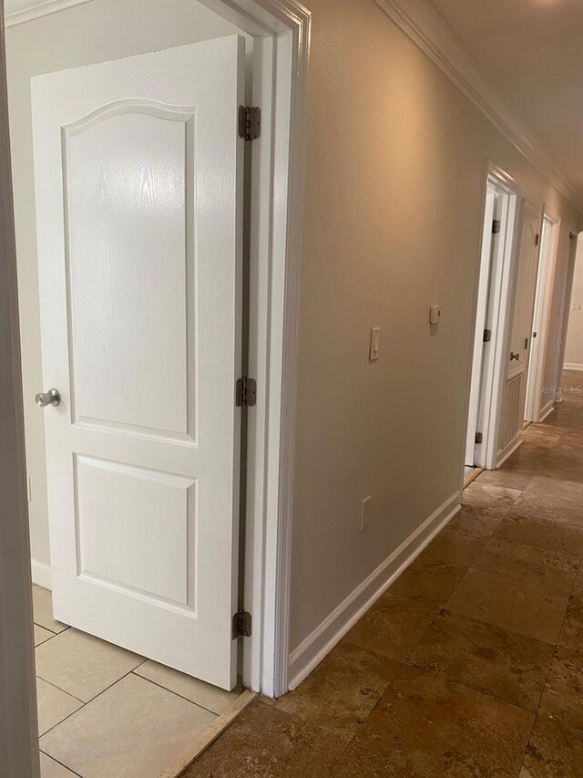 2007 Dixie Belle Dr Unit 2007M, Orlando, FL 32812 - hall featuring crown molding and baseboards