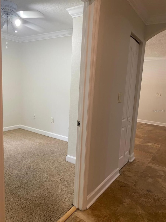 2007 Dixie Belle Dr Unit 2007M, Orlando, FL 32812 - corridor with crown molding, baseboards, a textured ceiling, and carpet flooring
